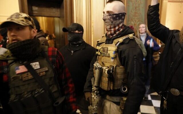 Right-wing protestors trying to enter the Michigan House of Representative chamber are kept out by the Michigan State Police at the Michigan State Capitol in Lansing, Michigan, April 30, 2020. (Jeff Kowalsky/AFP)