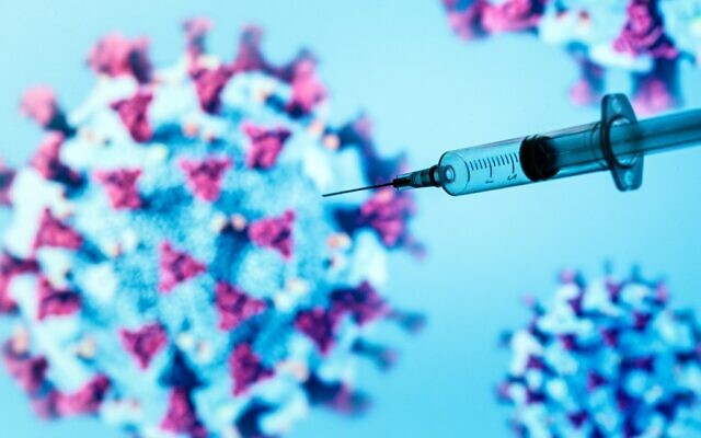 A syringe injects an illustrated representation of COVID-19, the disease caused by the novel coronavirus, in Paris, on May 18, 2020. (JOEL SAGET/AFP)