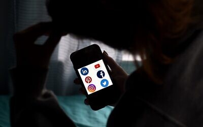 Illustrative: Icons of social media applications LinkedIn, YouTube, Pinterest, Facebook, Instagram, and Twitter, as displayed on a smartphone on May 28, 2020. (Olivier DOULIERY/AFP)