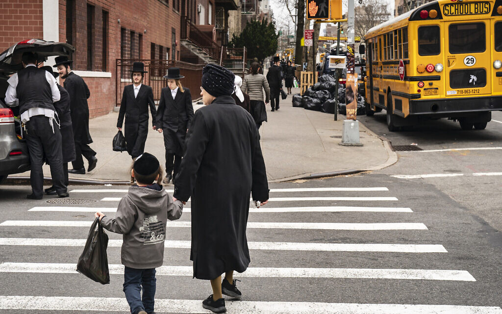 Illustrative: Pedestrians walk near the Yeshiva Kehilath Yakov School in the South Williamsburg neighborhood, April 9, 2019, in the Brooklyn borough of New York City. (Drew Angerer/Getty Images)