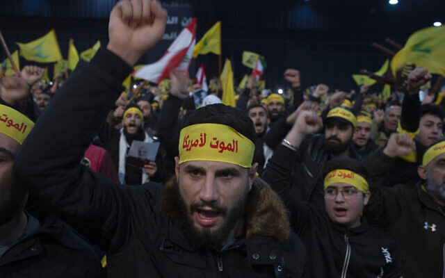 Supporters of Hezbollah terror group leader Hassan Nasrallah chant slogans ahead of his televised speech in a southern suburb of Beirut, Lebanon, January 5, 2020. (Maya Alleruzzo/AP)