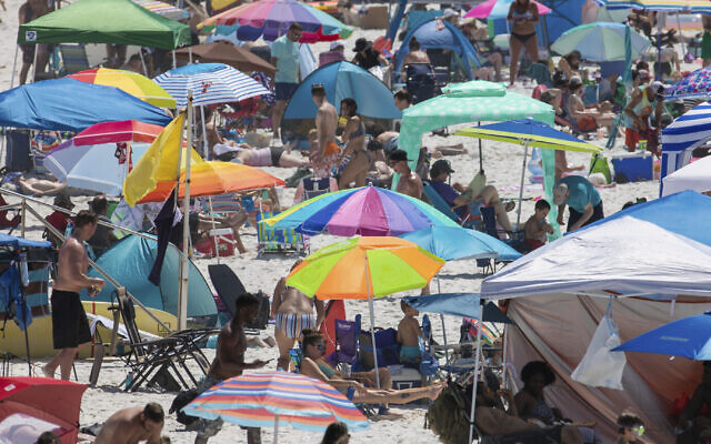 People visit Pensacola Beach in Pensacola, Fla., Saturday, May 23, 2020, during the coronavirus pandemic. (David Grunfeld/The Advocate via AP)