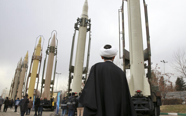 An Iranian cleric looks at domestically built surface-to-surface missiles at a military show marking  the 40th anniversary of Iran's Islamic Revolution that toppled the US-backed shah, at Imam Khomeini Grand Mosque, in Tehran, Iran, on February 3, 2019. (AP Photo/Vahid Salemi)