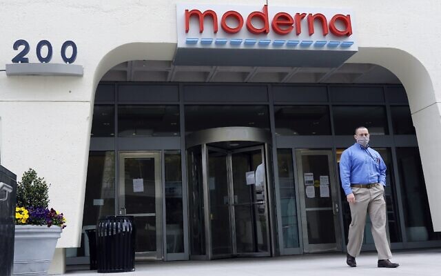 A man stands outside an entrance to a Moderna, Inc., building, Monday, May 18, 2020, in Cambridge, Mass. Moderna announced Monday that an experimental vaccine against the coronavirus showed encouraging results in very early testing, triggering hoped-for immune responses in eight healthy, middle-aged volunteers.(AP Photo/Bill Sikes)