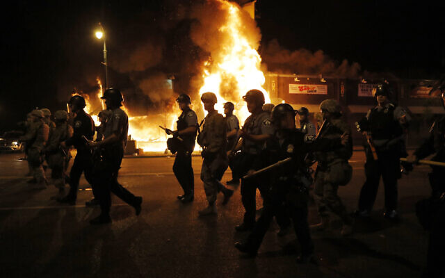 Police clear the street for firefighters during protests May 29, 2020, in Minneapolis (AP Photo/Julio Cortez)