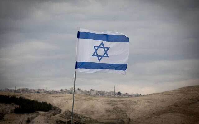 An Israeli flag is seen in the E1 area of the West Bank on January 2, 2017. (Yonatan Sindel/Flash90)