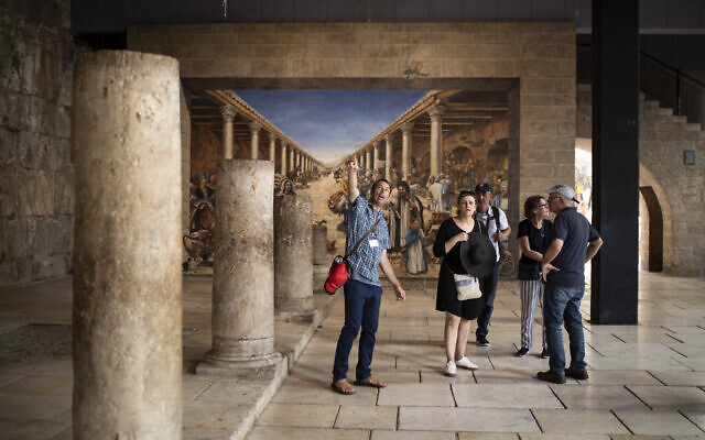 Tourists and their guide at the Cardo in the Jewish Quarter of Jerusalem's Old City in July 2019, months before the coronavirus would shutter Israeli tourism. (Hadas Parush/Flash 90)