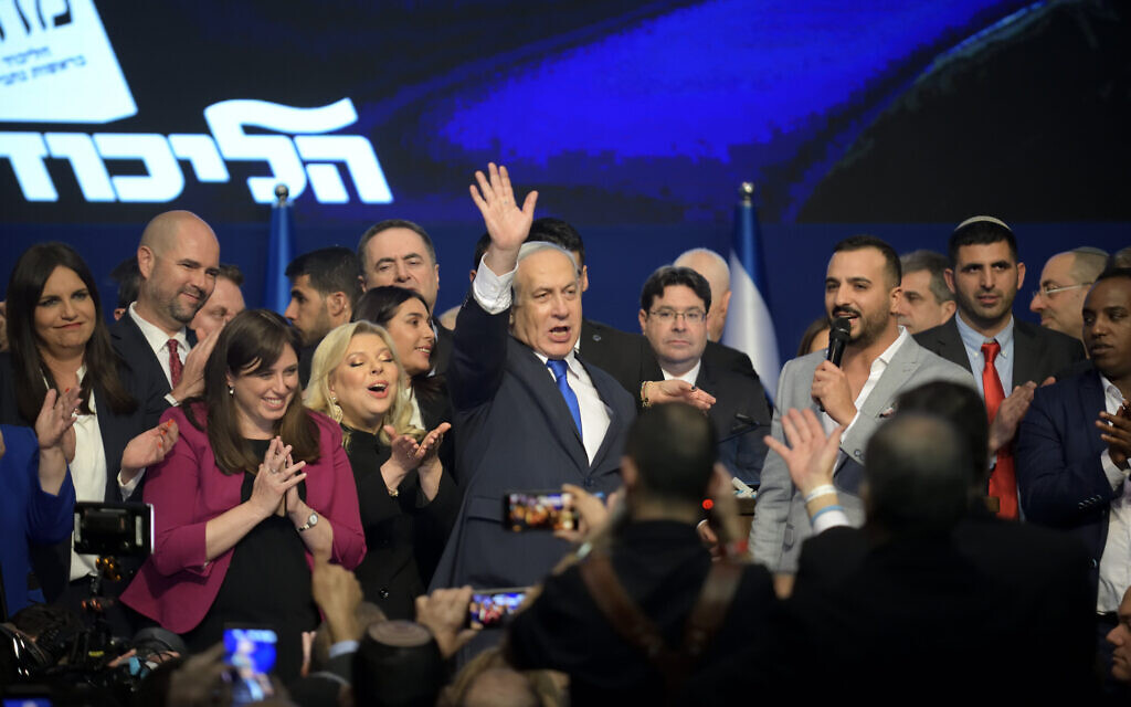 Prime Minister Benjamin Netanyahu, center, is flanked by Likud lawmakers at the party's post-election event in Tel Aviv, on March 2, 2020. (Gili Yaari/Flash90)