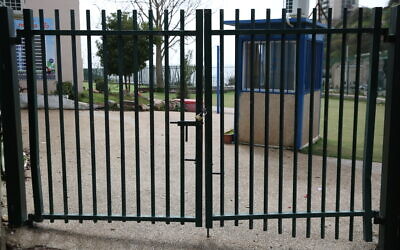 The closed gates of a school in Safed, northern Israel, March 13, 2020. (David Cohen/Flash90)
