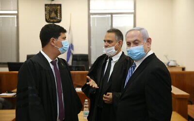 Prime Minister Benjamin Netanyahu (R) with his lawyers at the Jerusalem District Court for the start of his trial on corruption charges, May 24, 2020. (Amit Shabi/Pool/Flash90)