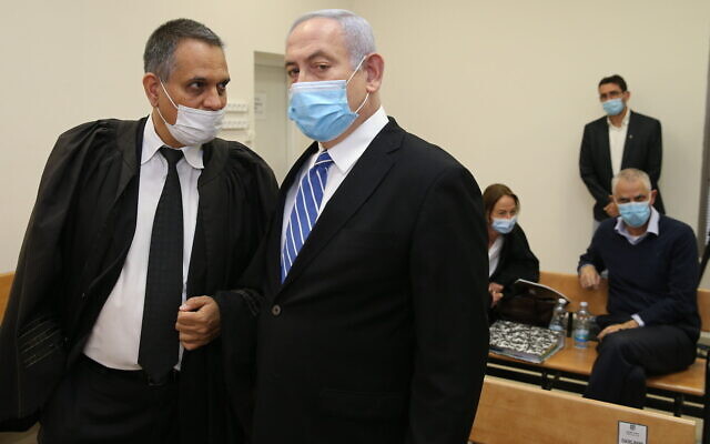 Prime Minister Benjamin Netanyahu and his lawyer Micah Fetman (L) at the Jerusalem District Court for the start of his trial on corruption charges, May 24, 2020. (Amit Shabi/Pool/Flash90)