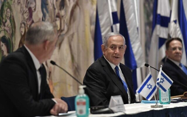 Then-prime minister Benjamin Netanyahu, center, Defense Minister Benny Gantz, left, and then-Cabinet Secretary Tzachi Braverman, at the first meeting of the 35th Government, in the Knesset on May 17, 2020. (Kobi Gideon/GPO)