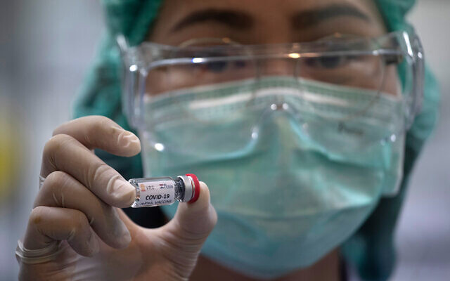 A lab technician holds a vial containing results for COVID-19 vaccine testing at the National Primate Research Center in Saraburi Province, north of Bangkok, Thailand, May 23, 2020. (AP/Sakchai Lalit)