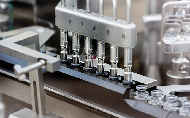 Rubber stoppers are placed onto filled vials of the remdesivir at a Gilead manufacturing site in the US, in March 2020. (Gilead Sciences via AP)