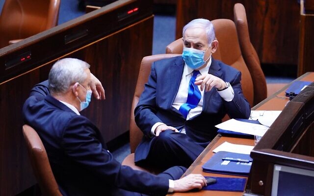 Blue and White chairman Benny Gantz (L) and Prime Minister Benjamin Netanyahu in the Knesset plenum on May 17, 2020, as their new coalition was sworn in. (Knesset)