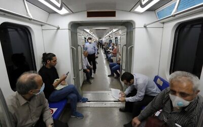 Iranians, mostly wearing face masks, are pictured in a train carriage at a metro station in the capital Tehran on June 10, 2020 amid the coronavirus pandemic crisis (STRINGER / AFP)