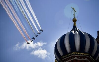 Russian Sukhoi Su-25 assault aircrafts release smoke in the colours of the Russian flag while flying over Red Square during a military parade, which marks the 75th anniversary of the Soviet victory over Nazi Germany in World War Two, in Moscow on June 24, 2020. (Alexander Nemenov/AFP)