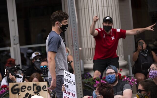 Minneapolis Mayor Jacob Frey (left) leaves a demonstration calling for the Minneapolis Police Department to be defunded on June 6, 2020, in Minneapolis, Minnesota, (Stephen Maturen/Getty Images/AFP)