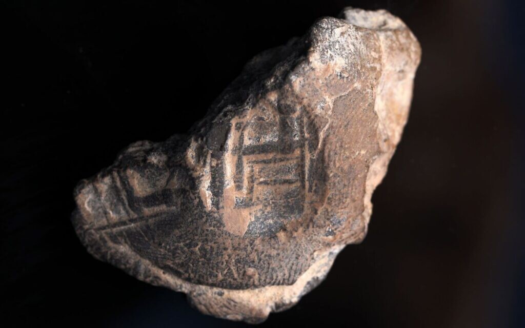 Stamp Seal featuring a man sitting on a big chair (maybe a king), in front of the man are  pillars, discovered in the City of David Givati Parking Lot excavations. (Shai Halevy, Israel Antiquities Authority)