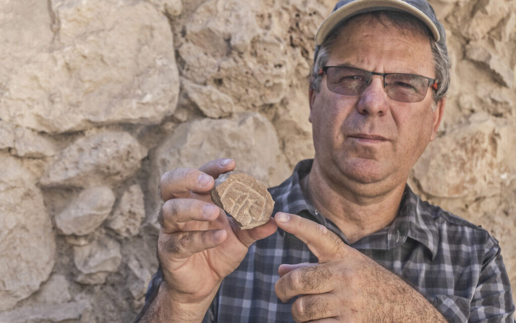Tel Aviv University Prof. Yuval Gadot with the Persian-era seal and seal impression discovered in the City of David's Givati Parking Lot excavations. 
(Shai Halevy, Israel Antiquities Authority)