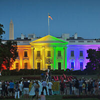 In this Friday, June 26, 2015 file photo, people gather in Lafayette Park to see the White House illuminated with rainbow colors in commemoration of the Supreme Court's ruling to legalize same-sex marriage in Washington. (AP/Pablo Martinez Monsivais)