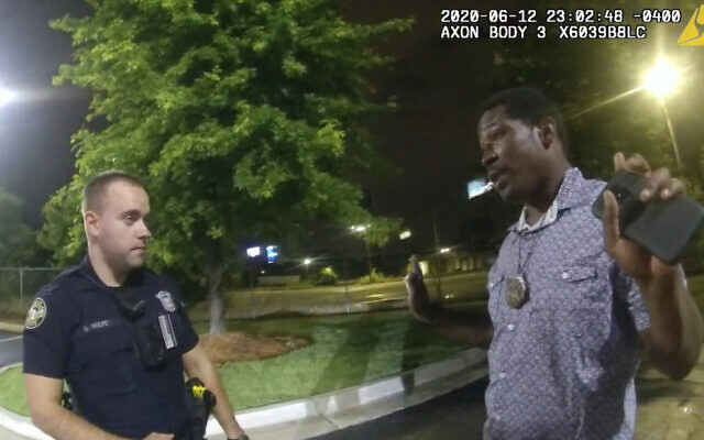 This screen grab taken from body camera video provided by the Atlanta Police Department shows Rayshard Brooks speaking with Officer Garrett Rolfe in the parking lot of a Wendy's restaurant, late Friday, June 12, 2020, in Atlanta. (Atlanta Police Department via AP)