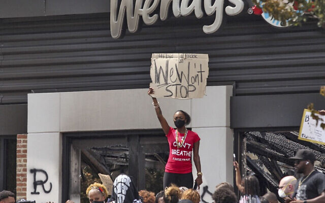 People hold a rally at Wendy’s on University Avenue in Atlanta on Sunday, June 14, 2020. Rayshard Brooks died after a confrontation with police officers at the fast food restaurant in Atlanta on Friday. (Steve Schaefer/Atlanta Journal-Constitution via AP)