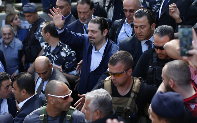 In this Sunday, May 8, 2016 file photo, Former Lebanese Prime Minister Saad Hariri, center, leader of Lebanon's parliamentary majority, waves to his supporters after he voted at a polling station during the municipal elections in Beirut, Lebanon. An explosion occurred earlier in June 2020 near the convoy of former Lebanese Prime Minister Saad Hariri when he was on a visit in a mountainous region in Lebanon's eastern Bekaa Valley, a Saudi-owned TV station reported Sunday, June 28. (AP Photo/Hassan Ammar)