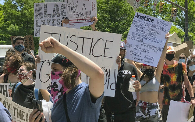 Protesters march past the Ohio Statehouse on Tuesday, June 2, 2020, in Columbus, Ohio, against the death of George Floyd, who died after being restrained by Minneapolis police officers on Memorial Day, May 25. (AP Photo/Andrew Welsh-Huggins)