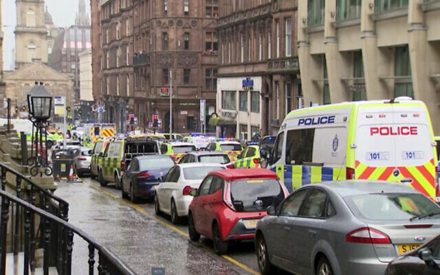 In this image taken from SKY video, emergency services attend the scene of incident in Glasgow, Scotland, Friday June 26, 2020. Police in Glasgow say emergency services are currently dealing with an incident in the center of Scotland's largest city and are urging people to avoid the area. (SKY via AP)