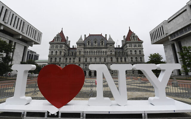 In this June 18, 2019, file photo, a new promotional "I Love NY" sign sits in the Empire State Plaza for installation in front of the New York state Capitol in Albany, New York (AP Photo/Hans Pennink, File)