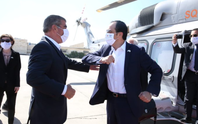 Foreign Minister Gabi Ashkenazi (L) greeting his Cypriot counterpart Nikos Christodoulides at Ben Gurion Airport, on June 23, 2020. (Foreign Ministry/courtesy)