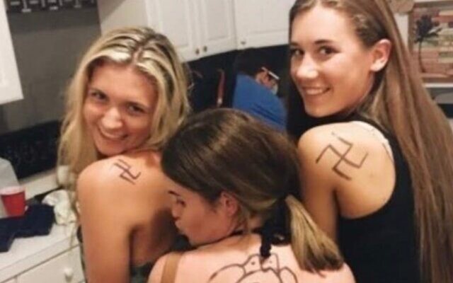 Penn State University student and friends sport swastikas drawn in marker on their shoulders. leading to condemnation from the university and fellow students. (Change.org via JTA)