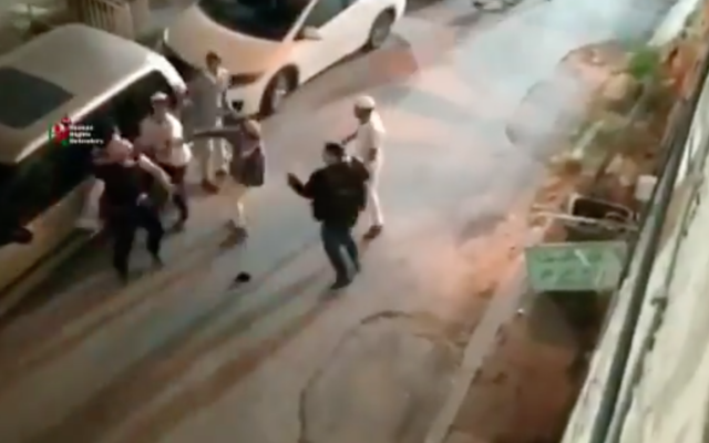 A Palestinian man is attacked by a group of Israelis in the West Bank city of Hebron on June 13, 2020. (Screen capture: Twitter)