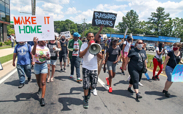 Protestors gather near a Wendy's restaurant where police killed a black man, Atlanta, Georgia, June 13, 2020. (Steve Schaefer/Atlanta Journal-Constitution via AP)