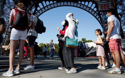 People line up to visit the Eiffel Tower, in Paris, June 25, 2020. (AP Photo/Thibault Camus)