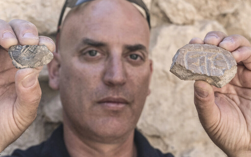 Israel Antiquities Authority's Dr. Yiftah Shalev with the Persian-era seal and seal impression discovered in the City of David's Givati Parking Lot excavations. 
(Shai Halevy, Israel Antiquities Authority)
