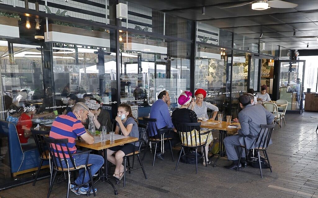 Israeli sit at a cafe in the West Bank settlement of Ariel, on July 1, 2020. (Jack Guez/AFP)