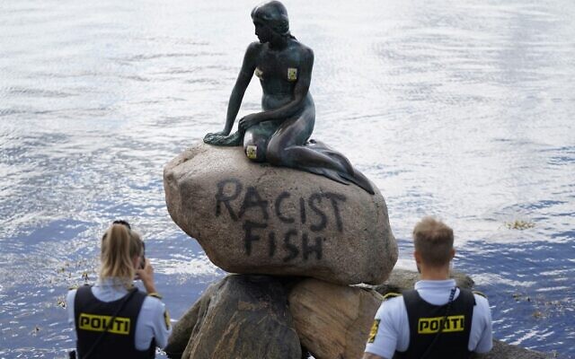 Danish police officers take pictures of the base of the Little Mermaid statue (Den lille Havfrue) after it was vandalized on July 3, 2020. (Mads Claus Rasmussen / Ritzau Scanpix / AFP) / Denmark OUT