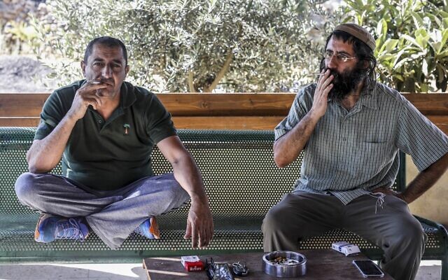 Khaled Abu Awad (L), a Palestinian from Bethlehem, and Shaul Judelman, an Israeli from the nearby Teqoa settlement, who are both co-directors of movement of settlers and Palestinians called 'Shorashim-Judur' (Hebrew and Arabic for 'Roots') pose, during an interview at the Gush Etzion Junction in the West Bank on July 3, 2020. (MENAHEM KAHANA/AFP)