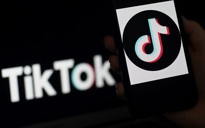 The social media application logo TikTok is displayed on the screen of an iPhone, in Arlington, Virginia, April 13, 2020. (Photo by Olivier DOULIERY / AFP)