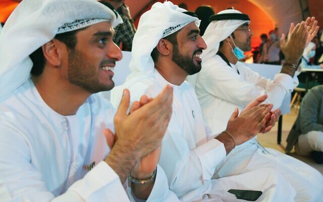Emirati men claps as they watch the launch of the "Amal" or "Hope" space probe at the Mohammed bin Rashid Space Center in Dubai, United Arab Emirates, Monday, July 20, 2020. A United Arab Emirates spacecraft, the "Amal" or "Hope" probe, blasted off to Mars from Japan early Monday, starting the Arab world's first interplanetary trip. (AP Photo/Jon Gambrell)