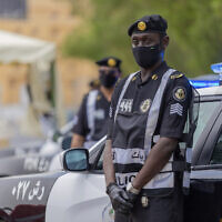 Policemen wearing gloves and face masks to help prevent the spread of the coronavirus provide security for pilgrims in Mecca, Saudi Arabia, July 26, 2020. (Saudi Ministry of Media via AP)