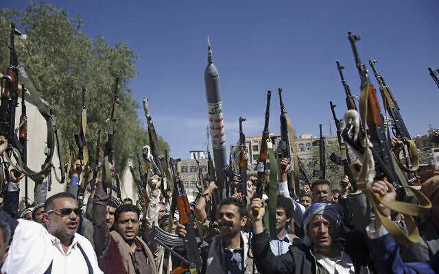 Tribesmen loyal to Yemen's Houthi rebels raise  their weapons as they chant slogans during a gathering aimed at mobilizing more fighters for the movement in Sanaa on February 25, 2020. (AP Photo/Hani Mohammed)