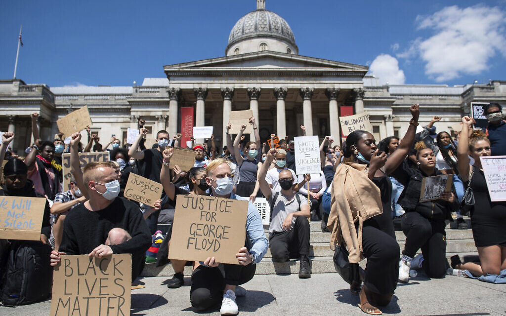 People take part in a Black Lives Matter protest in Trafalgar Square in London Sunday, May 31, 2020, to protest against the recent killing of George Floyd by police officers in Minneapolis, Minnesota. (Dominic Lipinski/PA via AP)