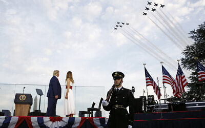 President Donald Trump and first lady Melania Trump watch as the US Air Force Thunderbirds and US Navy Blue Angels perform a flyover during a “Salute to America” event on the South Lawn of the White House, Saturday, July 4, 2020, in Washington. (AP/Patrick Semansky)
