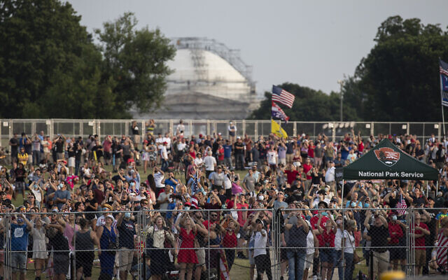 Crowds watch flyovers from the National Mall during a “Salute to America” event on the South Lawn of the White House, Saturday, July 4, 2020, in Washington. (AP/Alex Brandon)