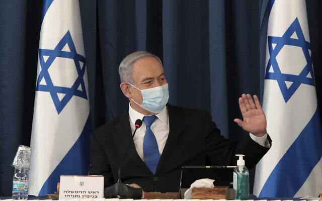 Prime Minister Benjamin Netanyahu wears a face mask to help prevent the spread of the coronavirus as he chairs the weekly cabinet meeting, at the Foreign Ministry, in Jerusalem, July 5, 2020. (Gali Tibbon/Pool via AP)