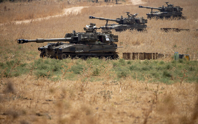 Israeli mobile artillery units sit in place in northern Israel near the border with Lebanon, July 28, 2020. (AP Photo/Ariel Schalit)