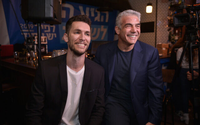 Yesh Atid party chairman Yair Lapid seen Idan Roll at a press conference in Tel Aviv, on February 7, 2019 (Flash90)